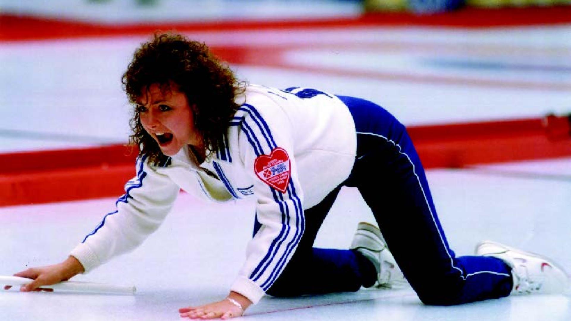 Kelly Law kneels on the ice, shouting instructions to her team at the curling rink.